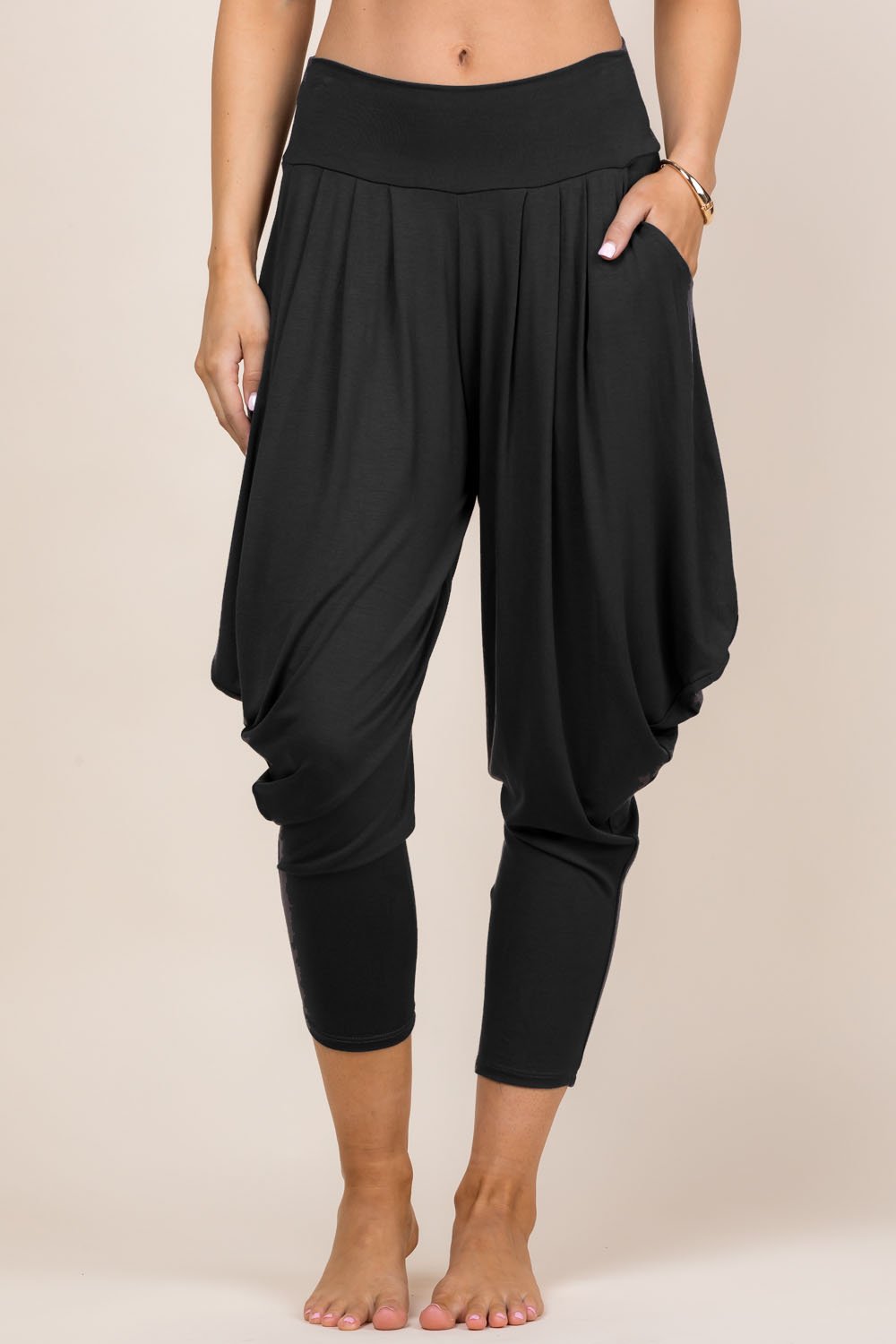 Front view of woman wearing black Kooniez harem pants with pockets – made in LA