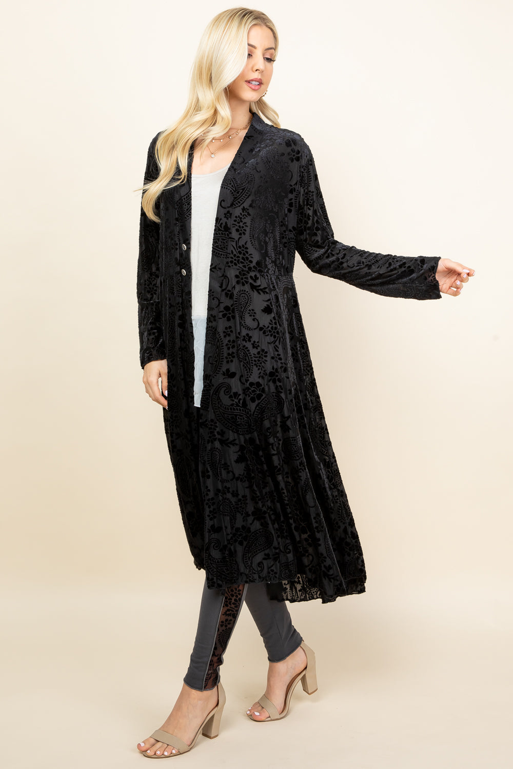 Front view of woman wearing black long velvet paisley jacket – boho duster, made in USA