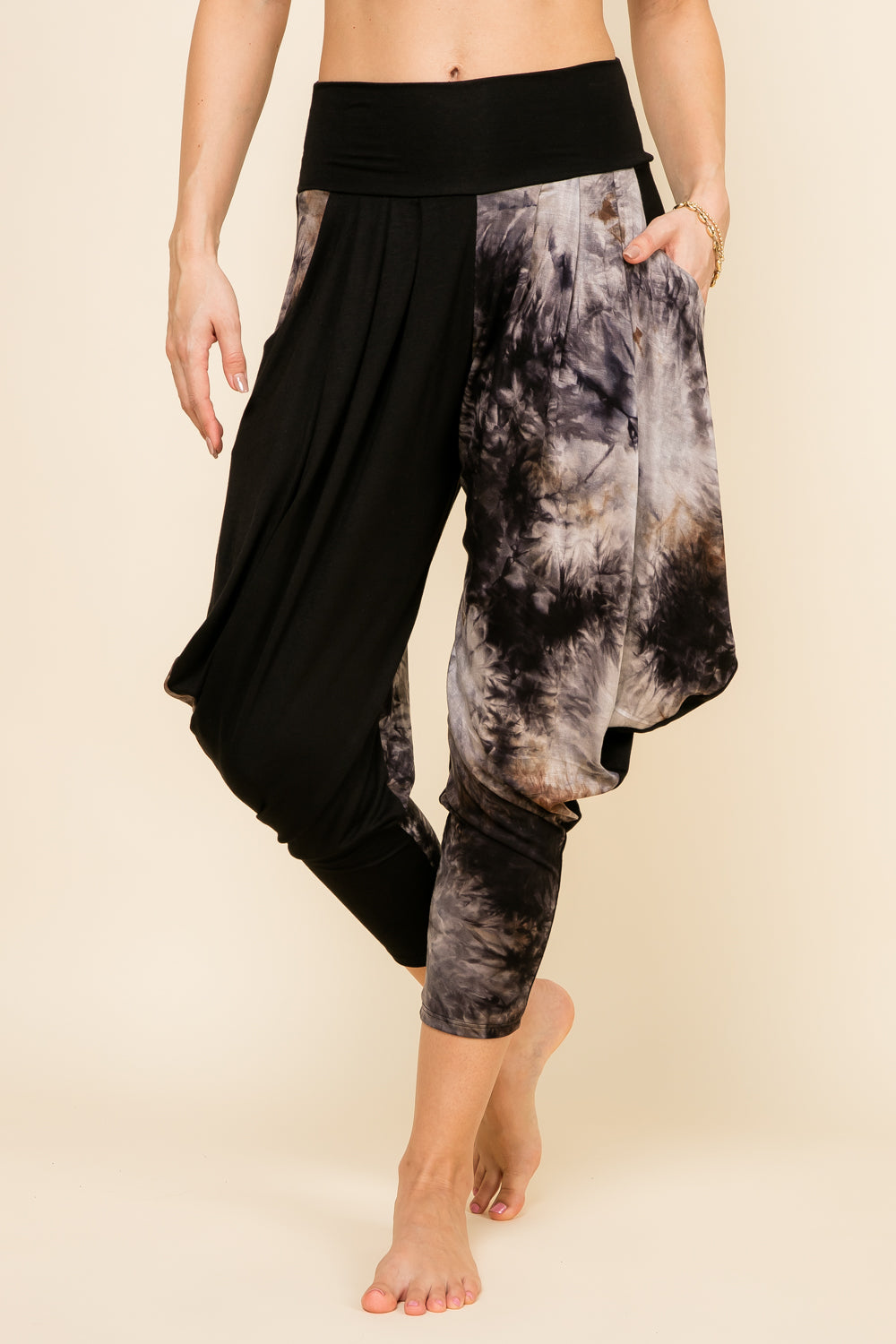 Front view of woman wearing black patchwork Kooniez harem pants with pockets – made in LA
