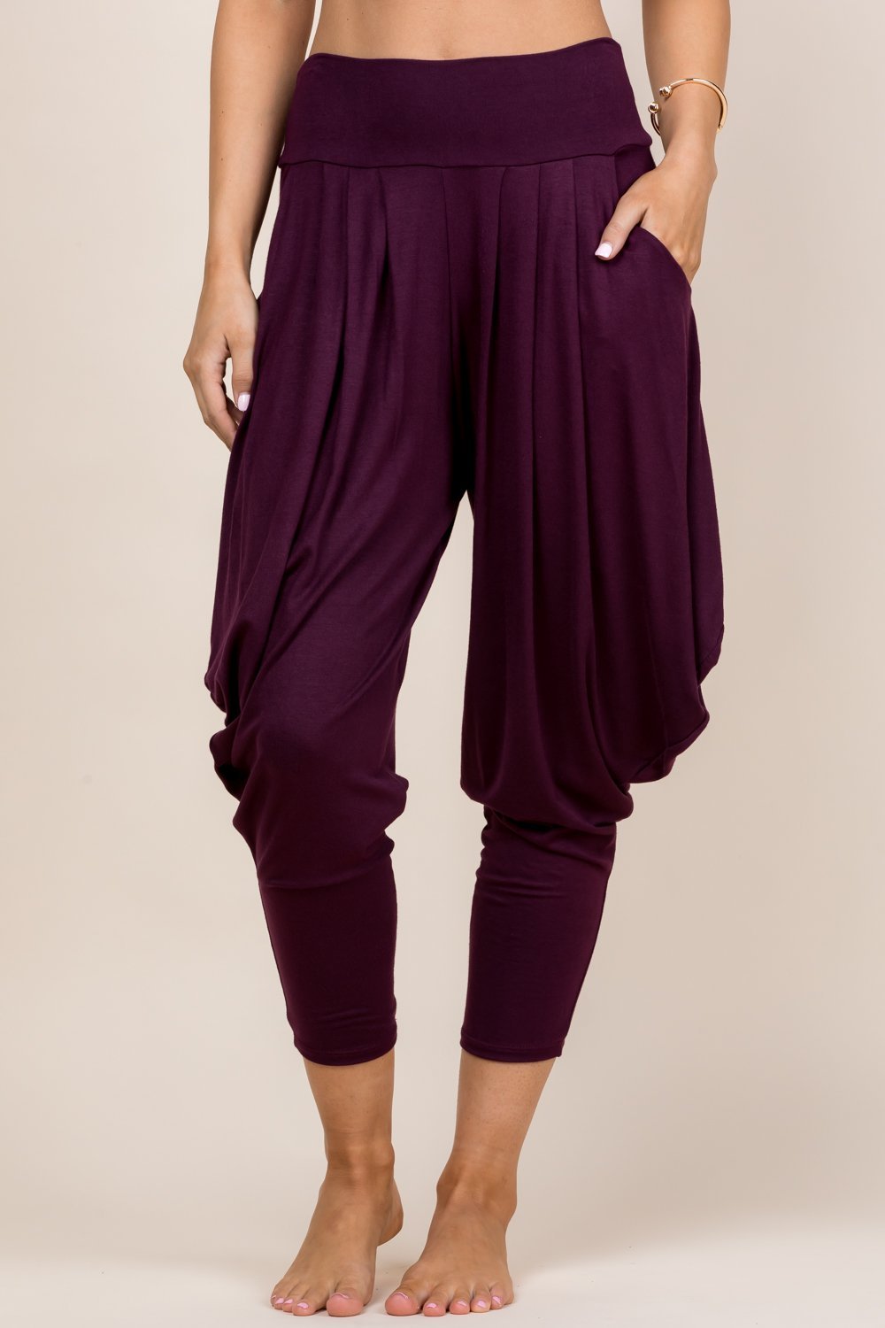 Front view of woman wearing burgundy Kooniez harem pants with pockets – made in LA