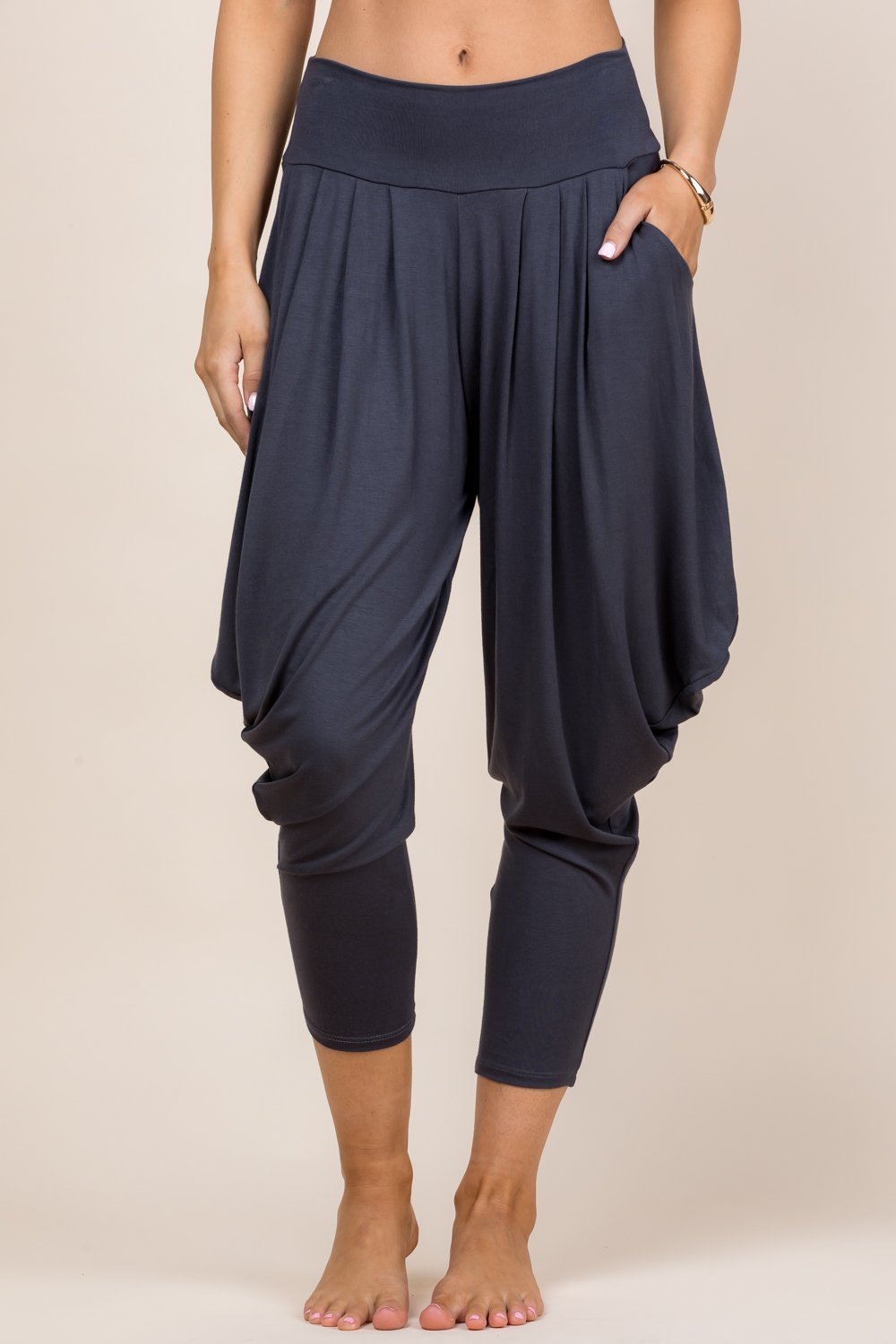 Front view of woman wearing charcoal Kooniez harem pants with pockets – made in LA