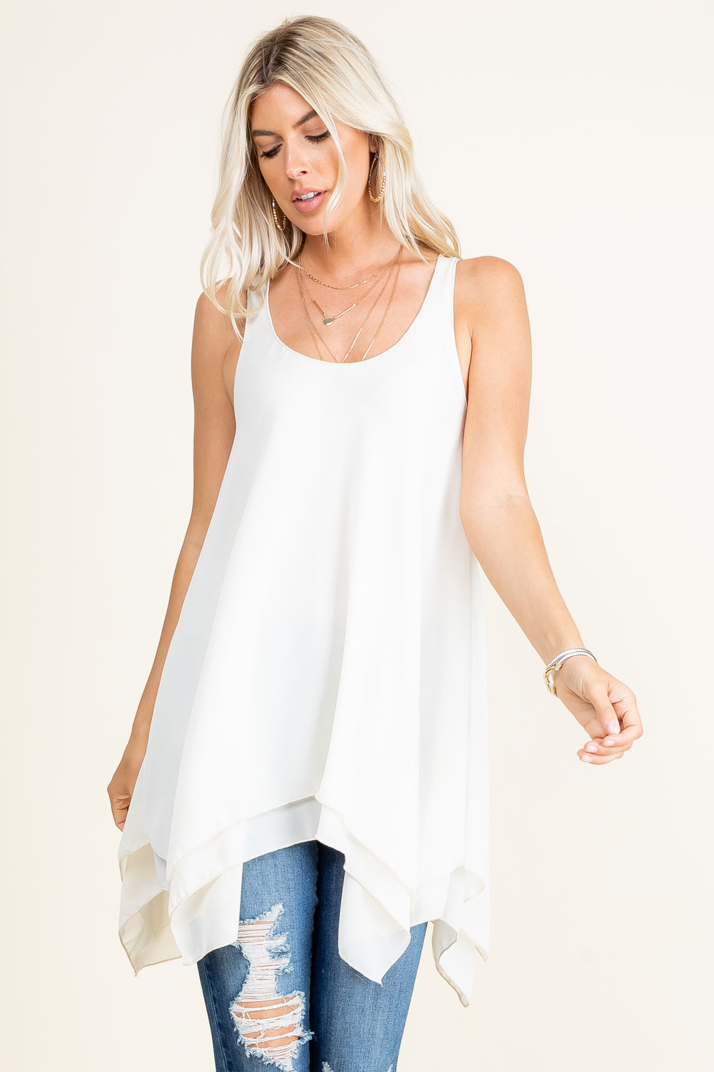 Front view of woman wearing ivory sleeveless swing tunic top – flowy and soft, made in USA