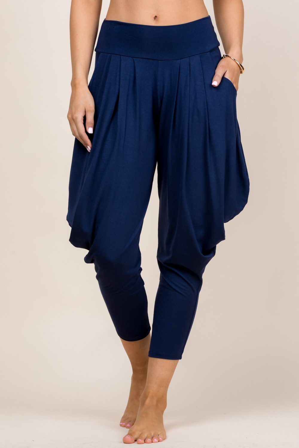 Front view of woman wearing navy blue Kooniez harem pants with pockets – made in LA