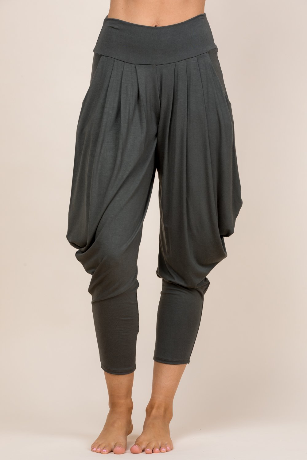 Front view of woman wearing olive Kooniez harem pants with pockets – made in LA