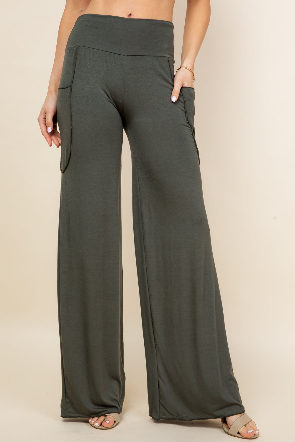 Front view of woman wearing olive palazzo wide leg pants – flowy lounge style, made in USA