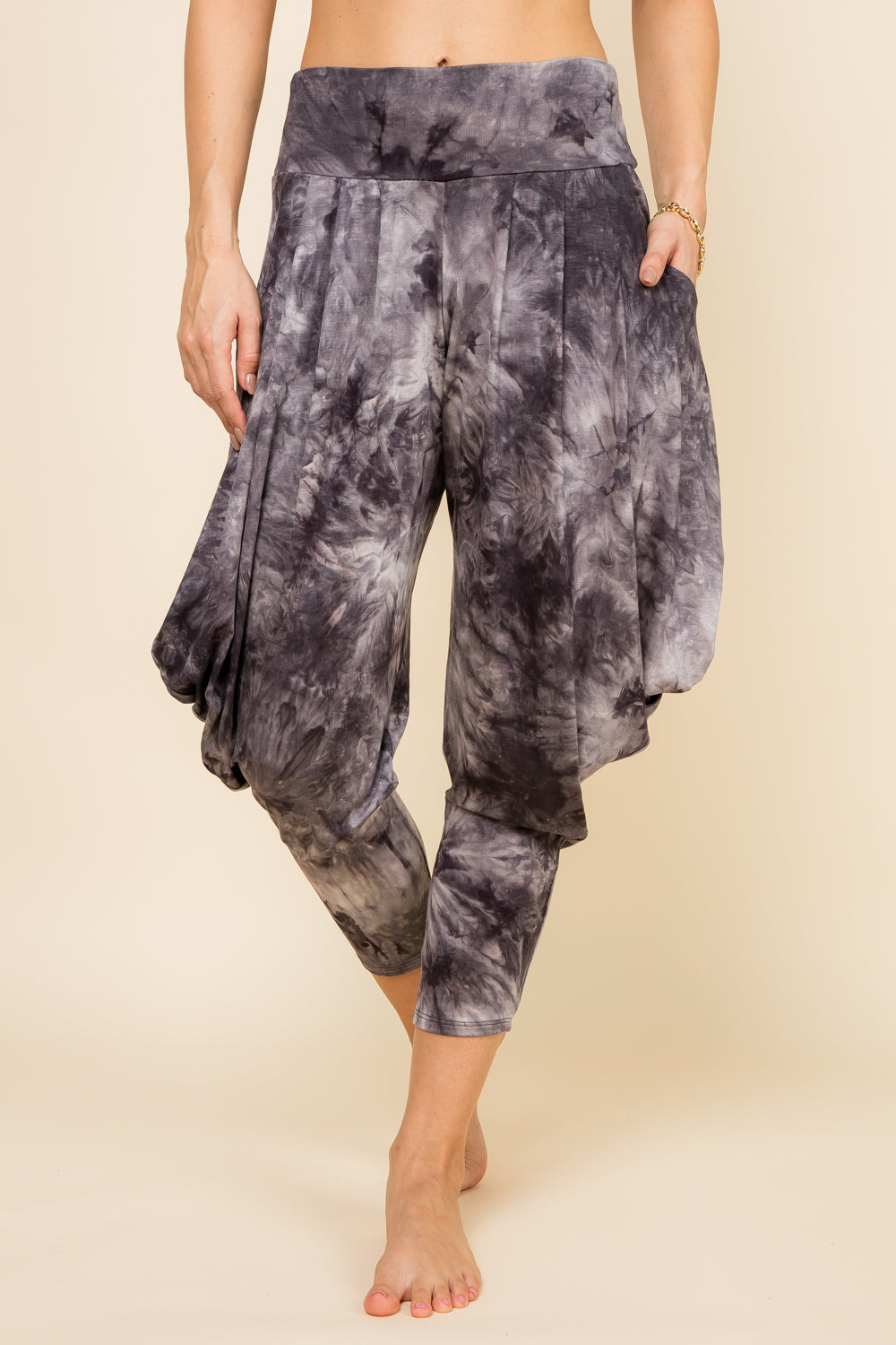 Front view of woman wearing black and white tie-dye Kooniez harem pants with pockets – made in LA