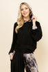Front view of woman wearing black tie-dye patchwork cropped hoodie – soft loungewear hoodie, made in USA
