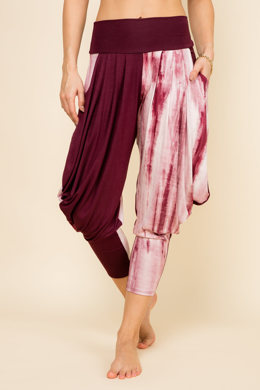 Front view of woman wearing burgundy marble patchwork Kooniez harem pants with pockets – made in LA