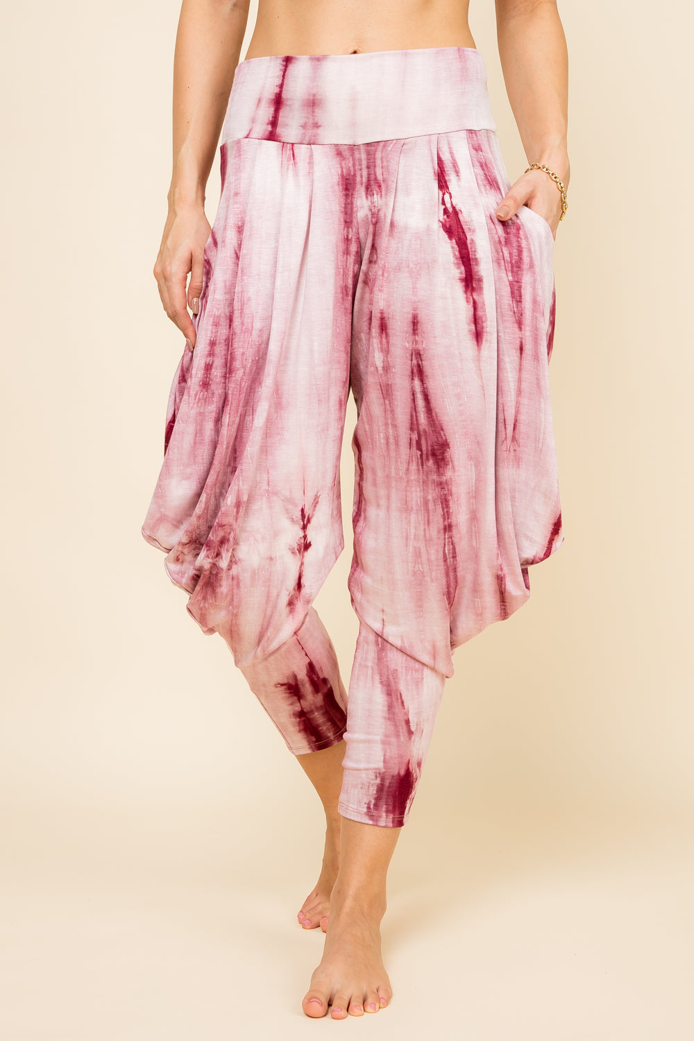 Front view of woman wearing burgundy marble tie-dye Kooniez harem pants with pockets – made in LA