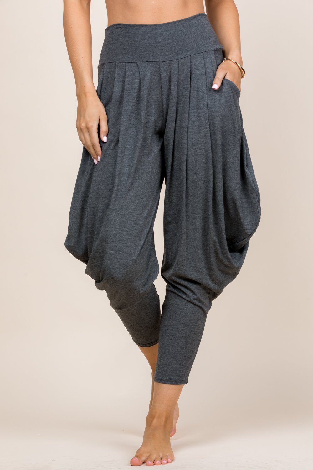 Front view of woman wearing dark heather Kooniez harem pants with pockets – made in LA
