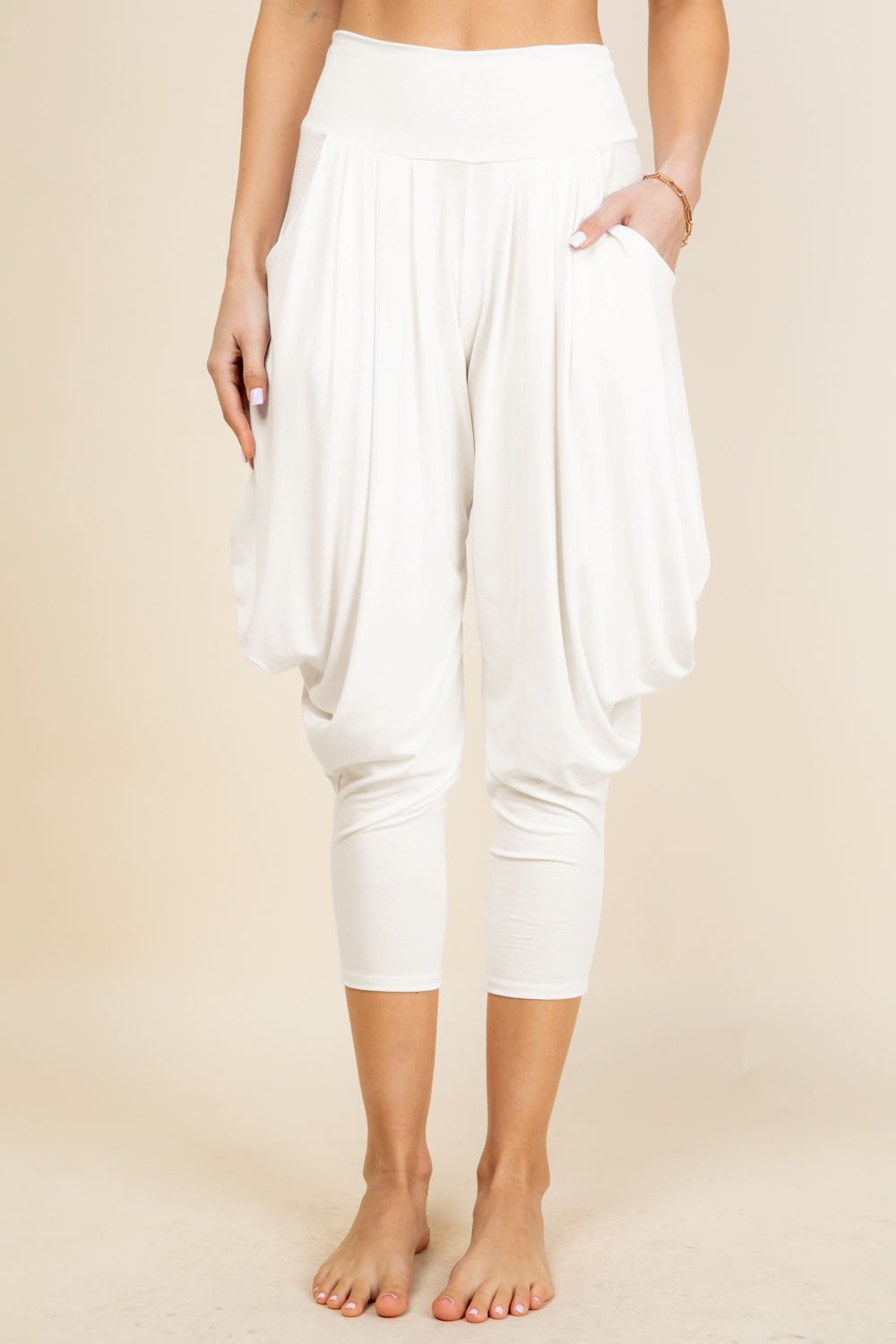 Front view of woman wearing ivory Kooniez harem pants with pockets – made in LA