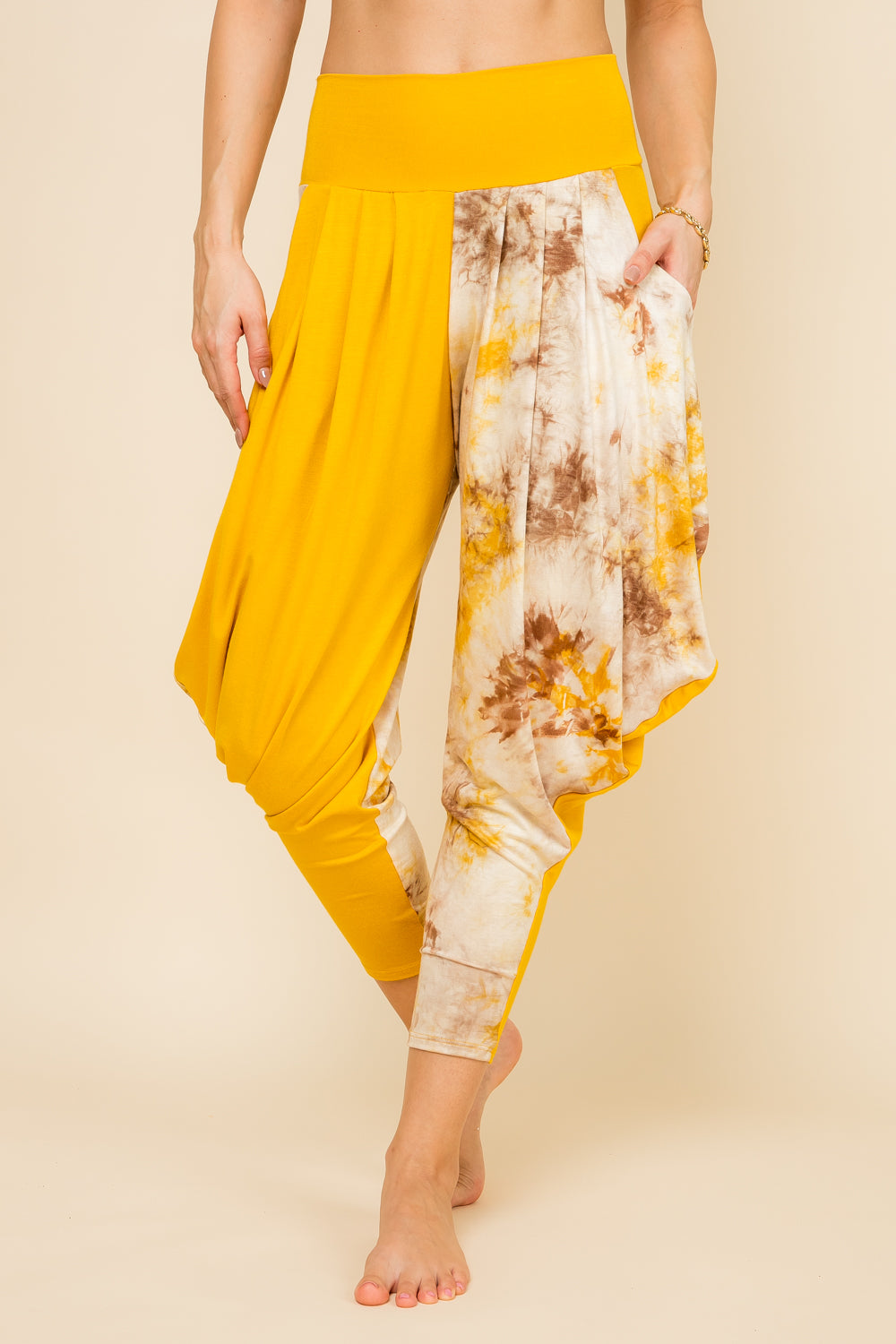 Front view of woman wearing mustard patchwork Kooniez harem pants with pockets – made in LA